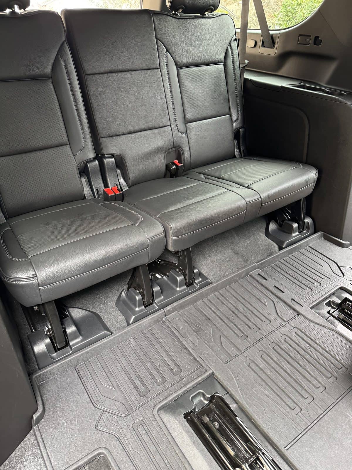 Cleaned rear bench seats and floor liners inside an SUV.